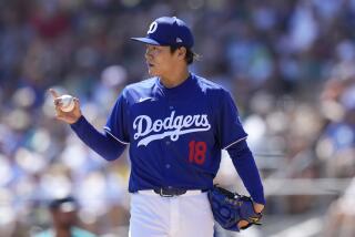 Los Angeles Dodgers starting pitcher Yoshinobu Yamamoto, of Japan, communicates with the infielders during the second inning of the team's spring training baseball game against the Seattle Mariners on Wednesday, March 13, 2024, in Phoenix. (AP Photo/Ross D. Franklin)