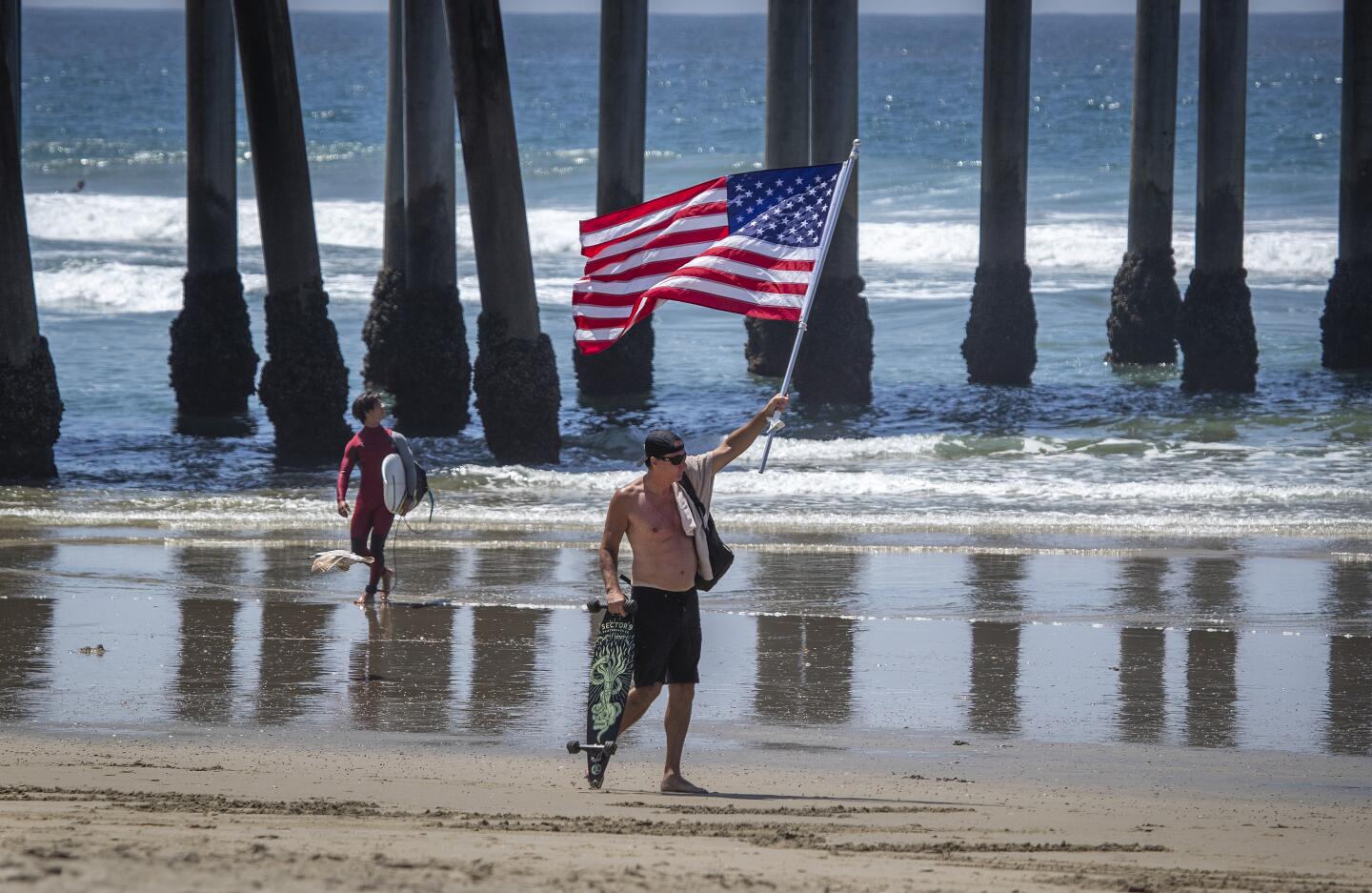 Protester waves U.S. flag in Huntington Beach