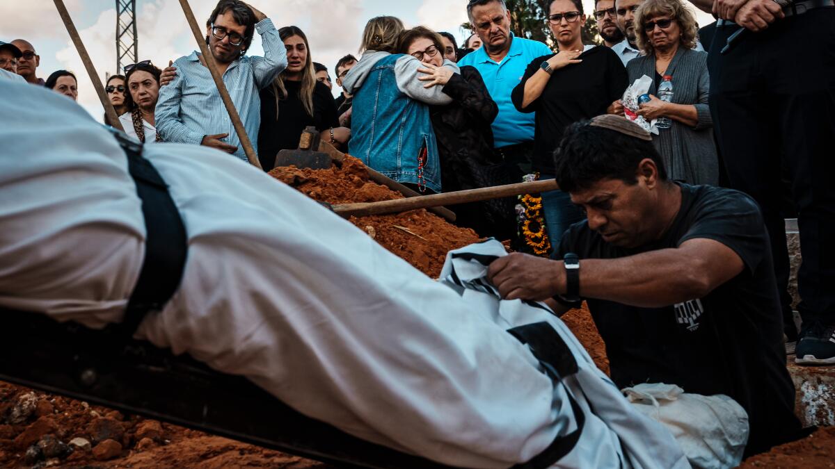 'I need to ask God why.' In Israel and Gaza, the scale of death overwhelms the living