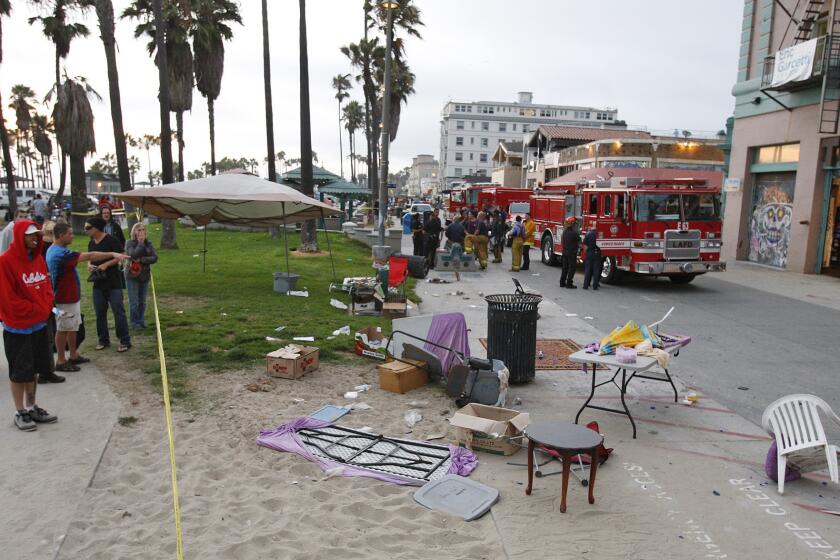 Debris litters the scene after a person drove a car onto the crowded Venice boardwalk and struck several people Saturday, killing one and injuring 16.