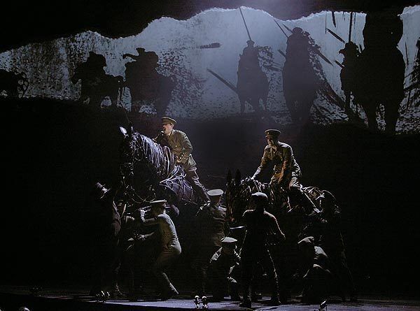 Grayson DeJusus (Capt. Charles Stewart), left, and Michael Waytt Cox (Billy Narracott) atop Joey prepare to charge into battle in the Tony-winning play "War Horse" at the Ahmanson Theatre.