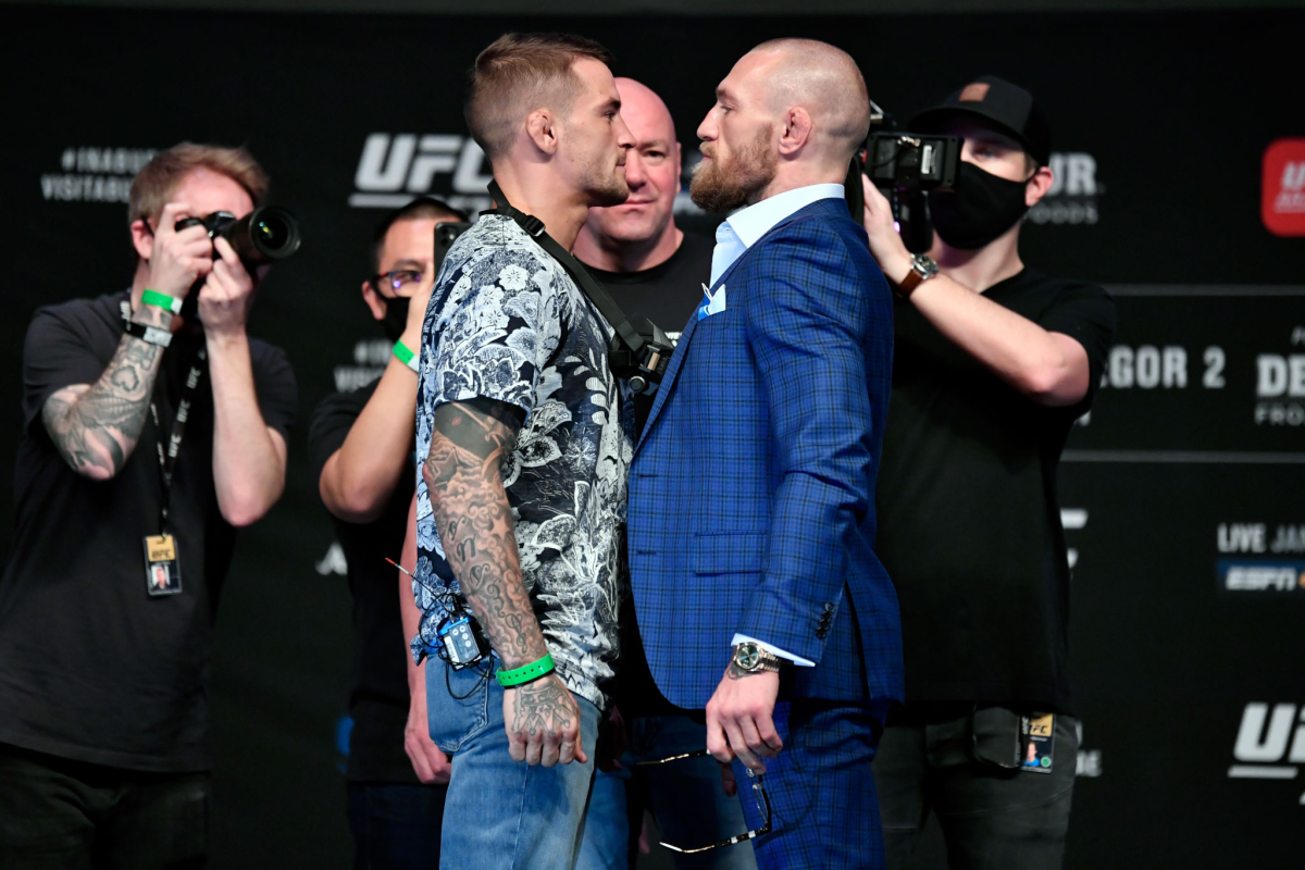 Dustin Poirier, left, and Conor McGregor face off for the media during their UFC 257 news conference.