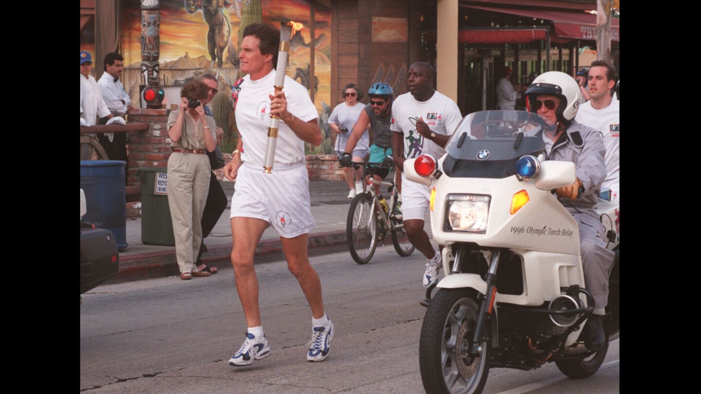 Jenner carries the Olympic Flame in the torch relay down Sunset Boulevard on April 27, 1996, nearly 20 years after his victory in the Olympic decathlon in Montreal.