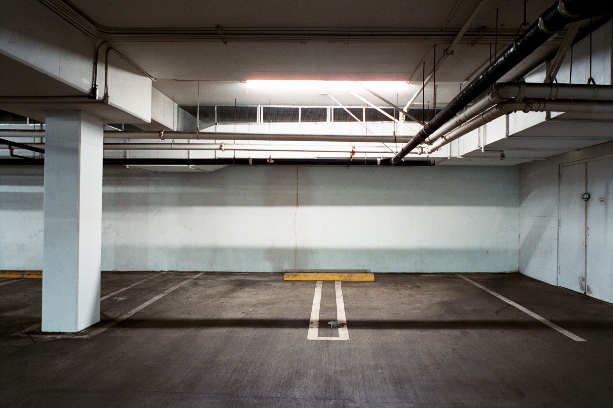 Two parking spaces lit with fluorescent light