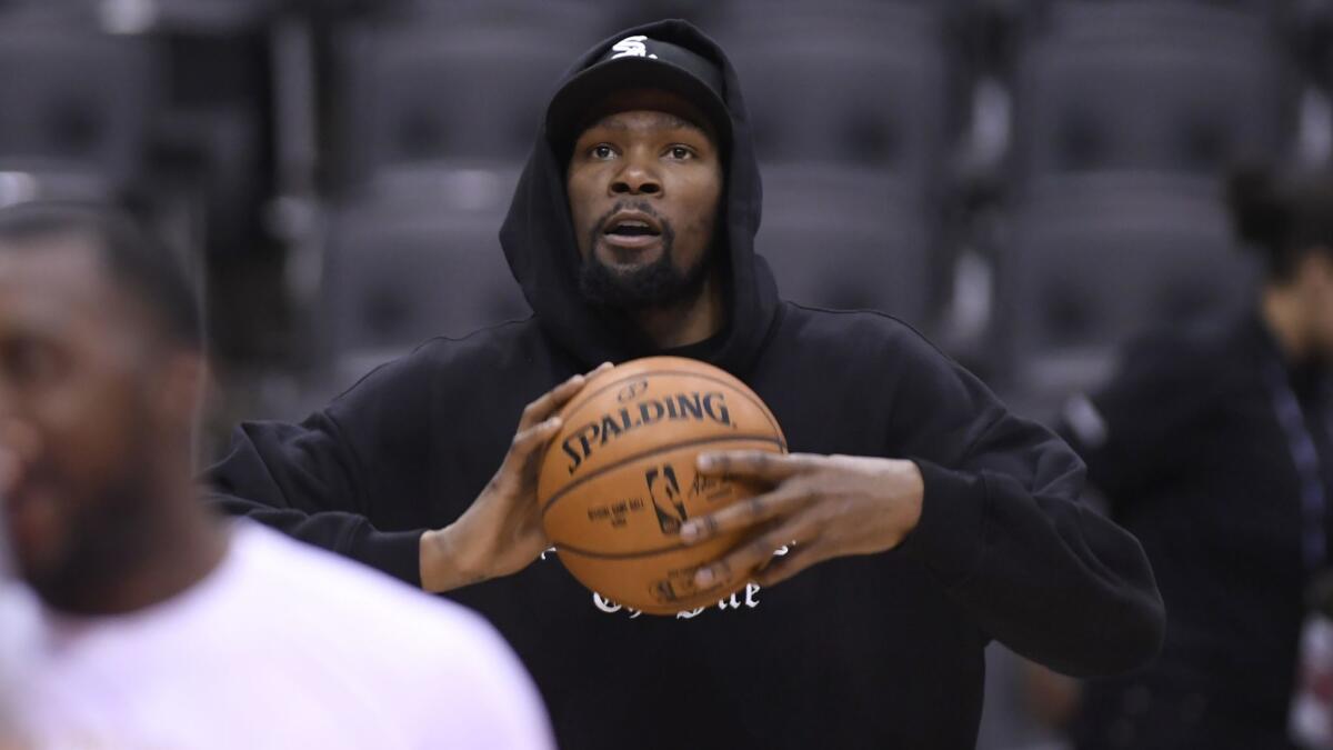 Kevin Durant watches during Golden State Warriors practice Saturday in Toronto. He is listed as questionable for Game 5 of the NBA Finals on Monday night.