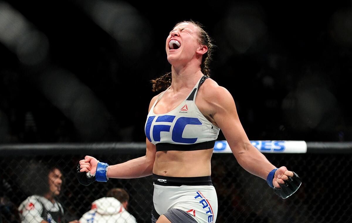 Miesha Tate celebrates after defeating Holly Holm at UFC 196 on Saturday night in Las Vegas.