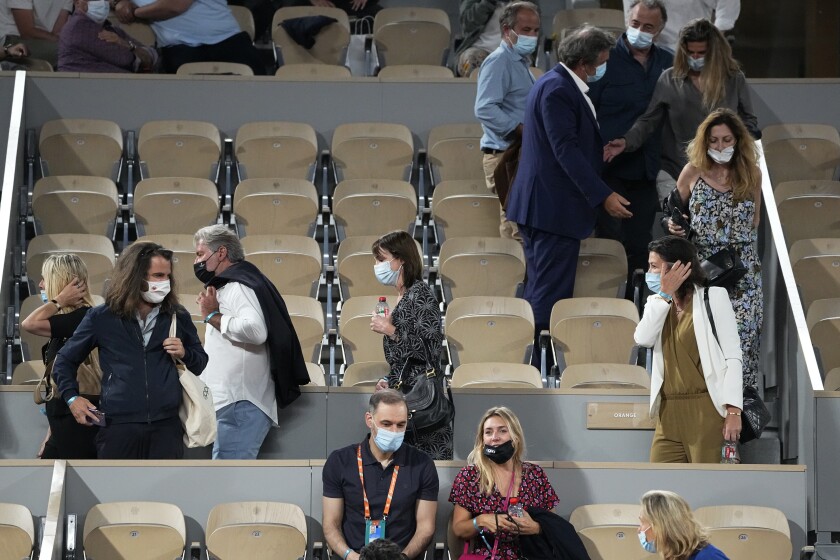Spectators leave to respect the 11PM curfew due to the COVID-19 pandemic while Italy's Matteo Berrettini plays Serbia's Novak Djokovic in a quarterfinal match of the French Open tennis tournament at the Roland Garros stadium Wednesday, June 9, 2021 in Paris. (AP Photo/Michel Euler)