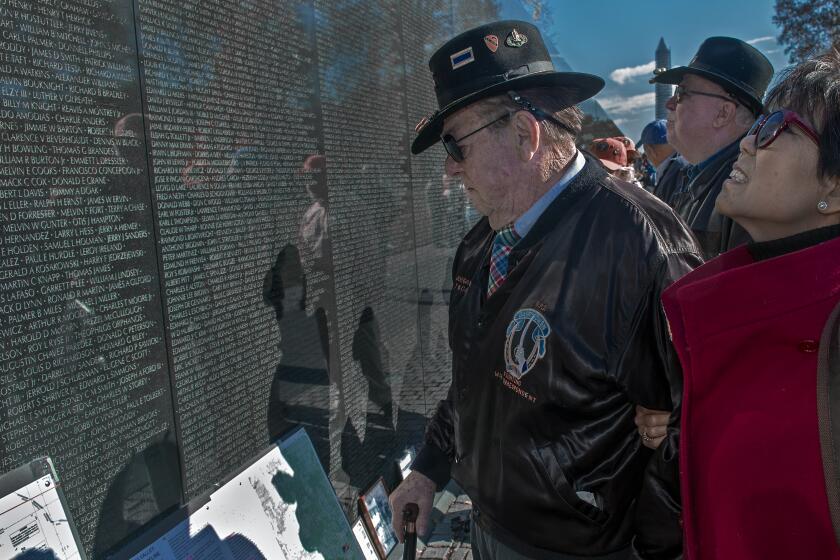 War author and correspondent Joseph Galloway and his wife Grace at the Vietnam Memorial wall in 2013.