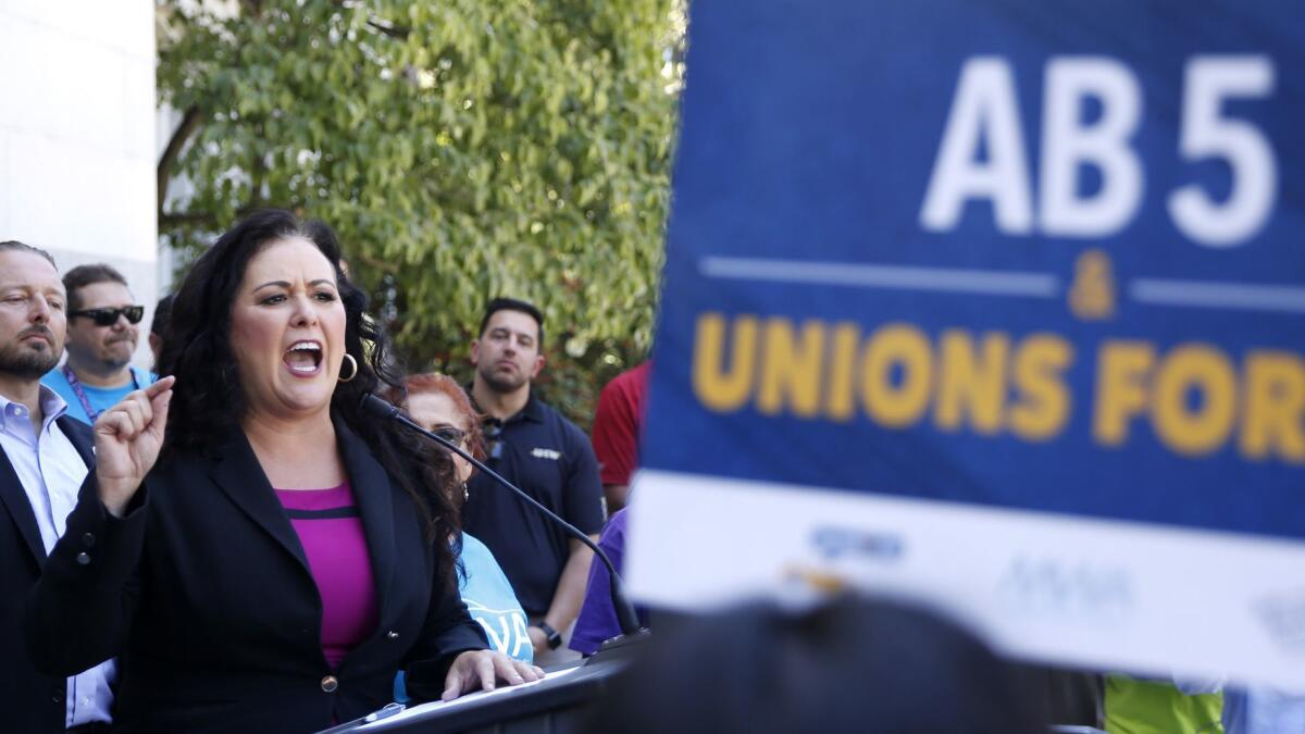 Assemblywoman Lorena Gonzalez (D-San Diego) speaks at a rally after her measure to limit when companies can label workers as independent contractors was approved by a Senate committee July 10.