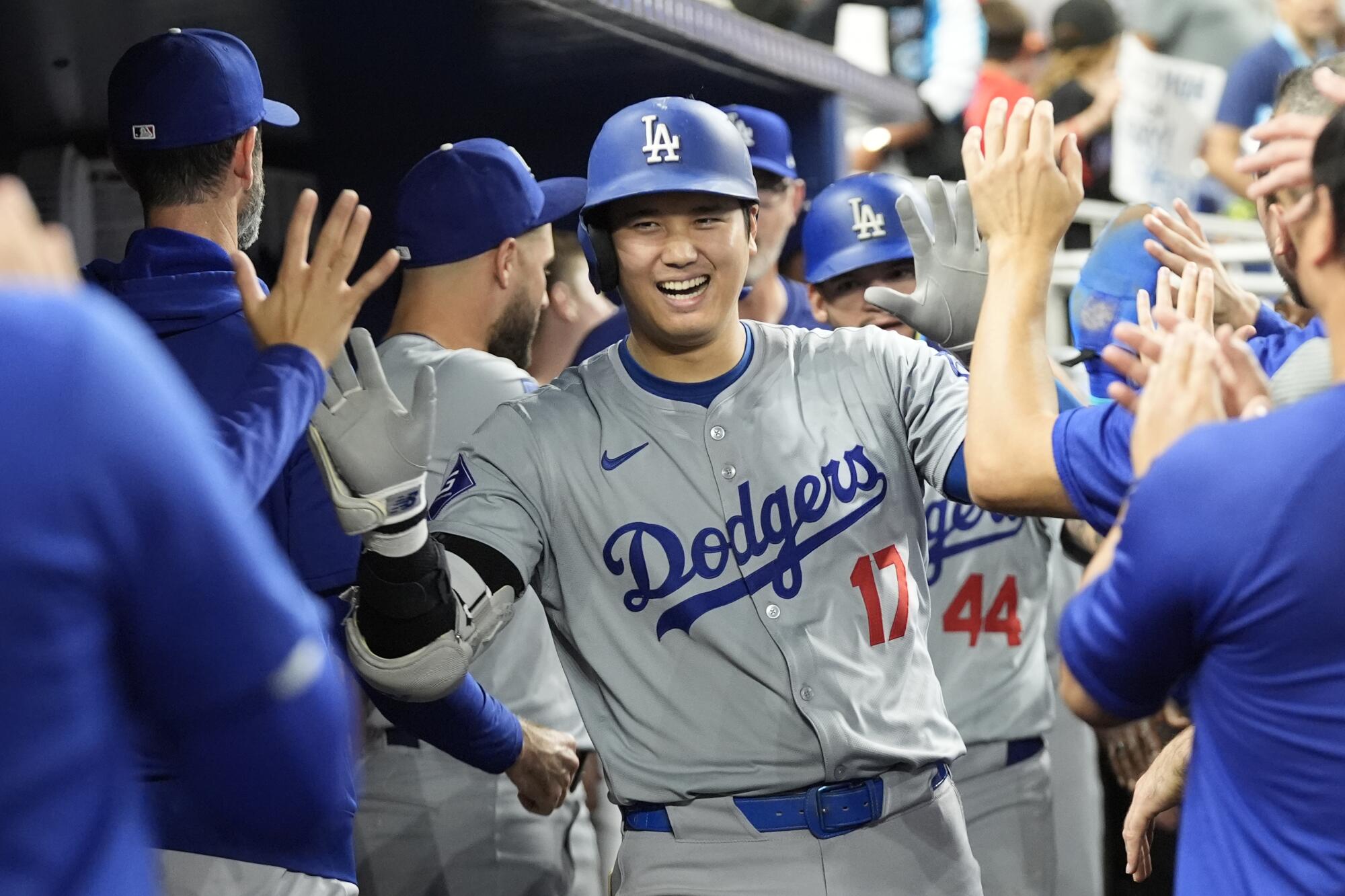 Shohei Ohtani celebrates with teammates after hitting the first of three home runs during a 20-4 win over the Miami Marlins.