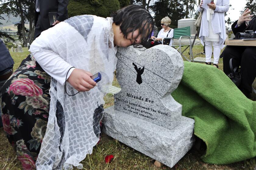 More than 100 people attended a ceremony for the girl's reburial in Colma, less than 10 miles from where she was originally buried. They christened her Miranda Eve.