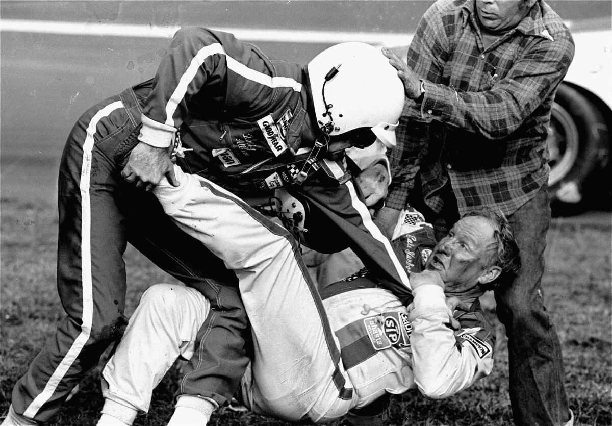 Bobby Allison stands over Cale Yarborough during a fight that broke out at the Daytona 500 on Feb. 18, 1979.