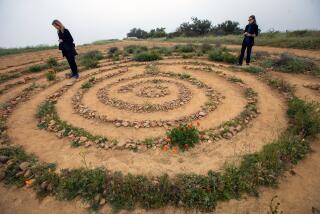 Topanga, CA - April 12: Katie Bull, left, and Dana Bain, right, walk a labyrinth on Wednesday, April 12, 2023, in Topanga, CA. (Francine Orr / Los Angeles Times)