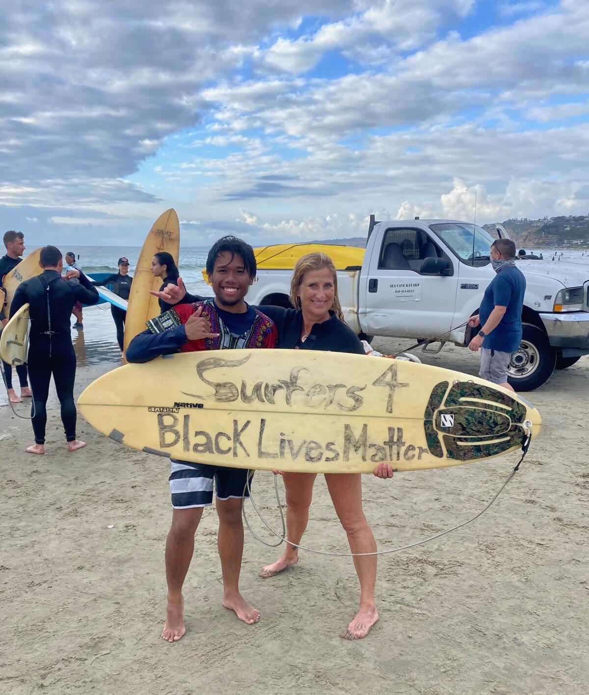 Harley Sobreo and event organizer Leanne Tibiatowski attend the paddle-out at La Jolla Shores to support Black Lives Matter.