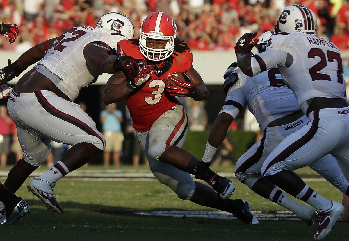 Georgia running back Todd Gurley splits between South Carolina defenders during the second half of a game on September 7, 2013.