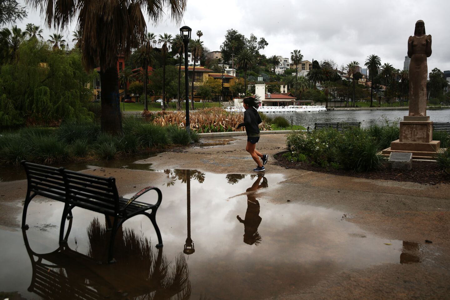 A person runs around Echo Park Lake after a rainstorm in Los Angeles.