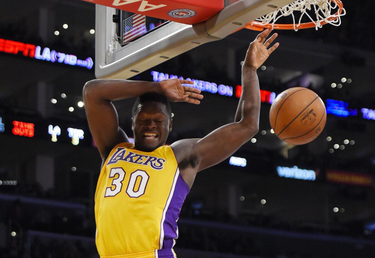 Lakers forward Julius Randle dunks during the second half of a game against the Raptors.