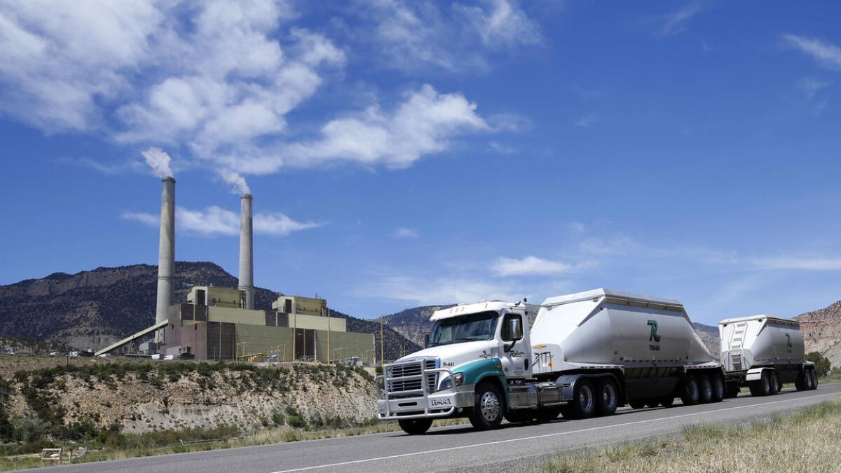 Coal trucks leave a power plant operated by PacifiCorp outside Huntington, Utah.