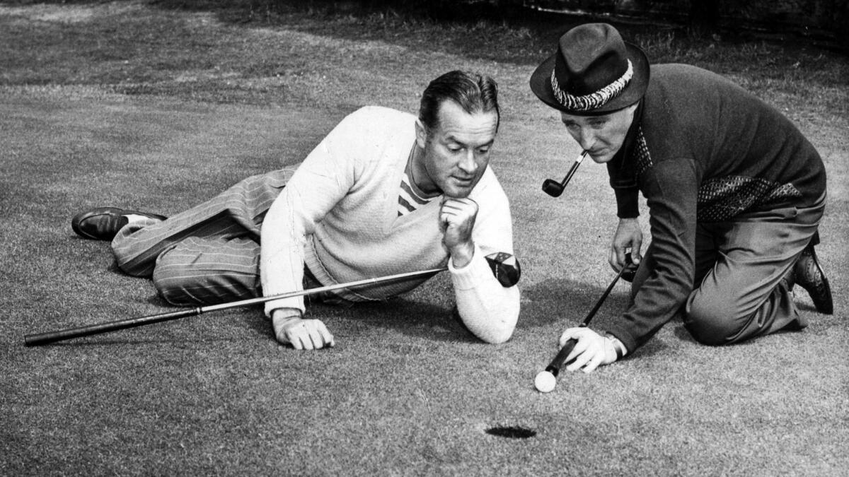 Jan. 25, 1946: Bob Hope admires the technique of Bing Crosby in promotional photo for charity golf exhibition.