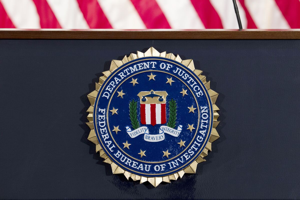 FILE - This June 14, 2018 file photo shows an FBI seal on a podium before a news conference at the agency's headquarters in Washington. The FBI and other federal government agencies are increasingly looking to counter cyber threats through tools other than criminal indictments. That's according to the bureau’s top cyber official. (AP Photo/Jose Luis Magana, File)