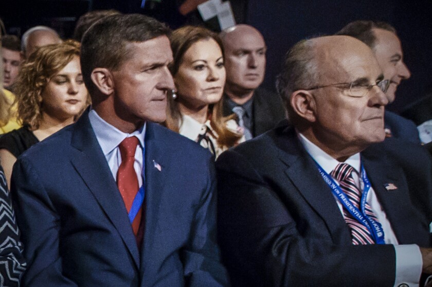 FILE - Former Defense Intelligence Agency Director Michael Flynn, left, and former New York Mayor Rudy Giuliani, right, wait for the start of the first presidential debate between Republican candidate Donald Trump and Democratic candidate Hillary Clinton at Hofstra University, Monday, Sept. 26, 2016, in Hempstead, N.Y. The University of Rhode Island is revoking honorary degrees bestowed upon Flynn and Giuliani. The university’s board of trustees voted Friday, Jan. 21, 2022, to revoke the degrees following internal deliberations. (AP Photo/ Evan Vucci, Fie)