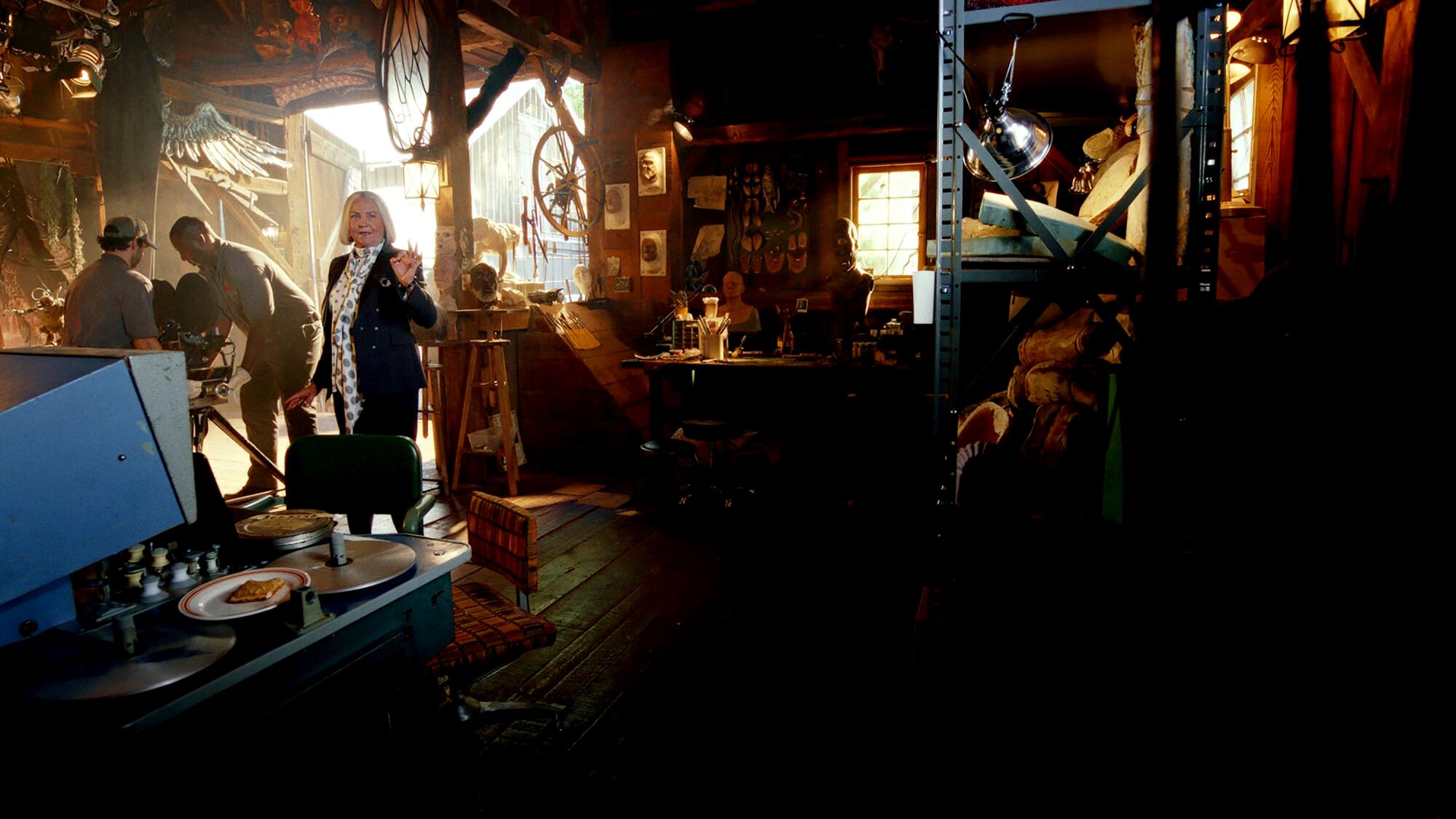 Actress Cherry Jones stands in a cluttered barn-like space on the "Poker Face" set. 