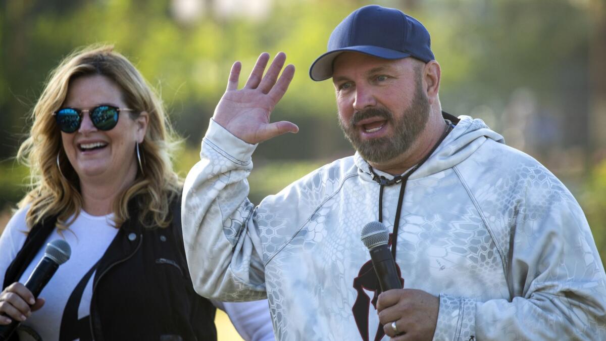Trisha Yearwood and Garth Brooks answer questions from the media before performing Sunday to close out the three-day Stagecoach Country Music Festival in Indio.
