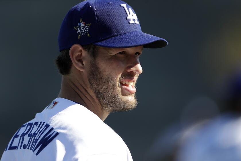 Los Angeles Dodgers pitcher Clayton Kershaw looks on during spring training baseball Thursday, Feb. 20, 2020, in Phoenix. (AP Photo/Gregory Bull)