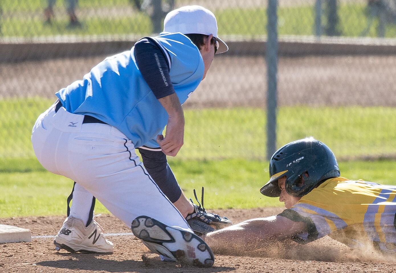 Marina's Kyle Hines tags out Edison's Derek Cleland at third on a stolen base attempt during a Sunset League game on Thursday, March 15.