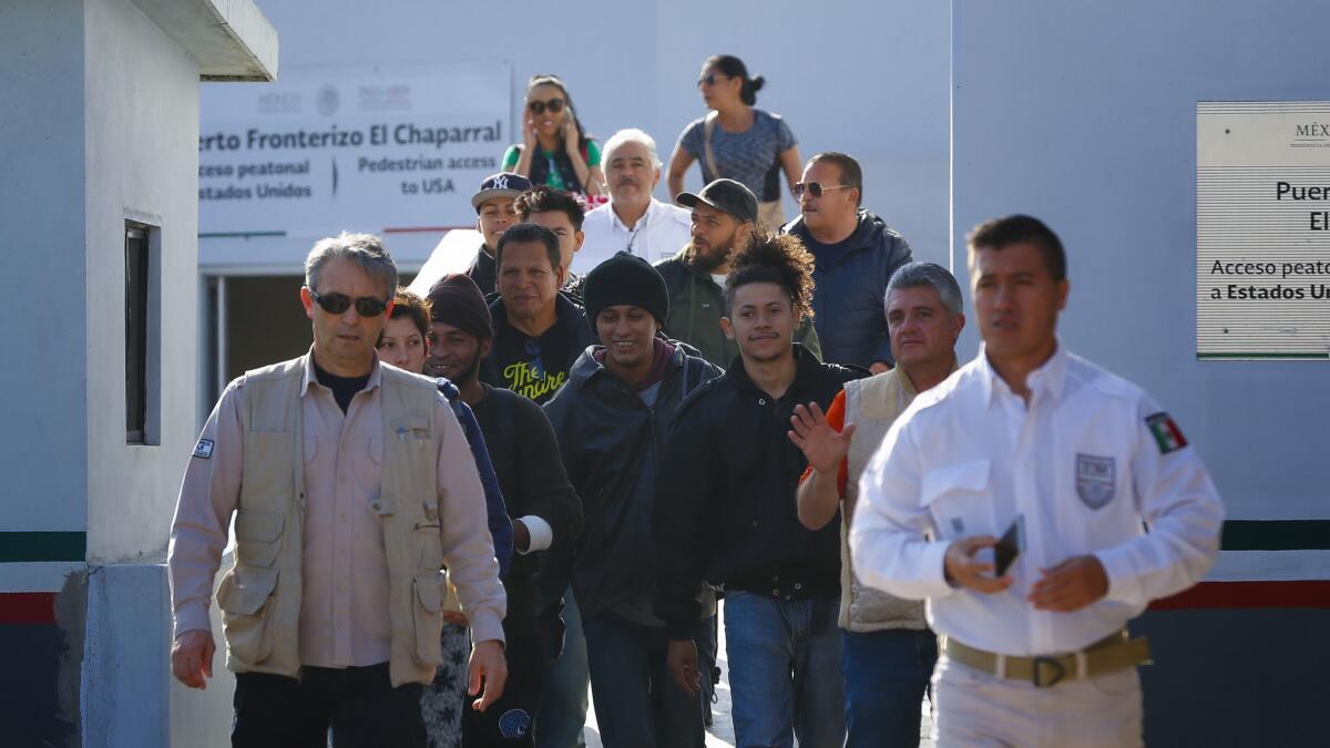A group of migrants that were under CBP custody in San Diego for processing during their initial request for asylum in the U.S. are returned to Mexico at El Chaparral port of entry in Mexico.