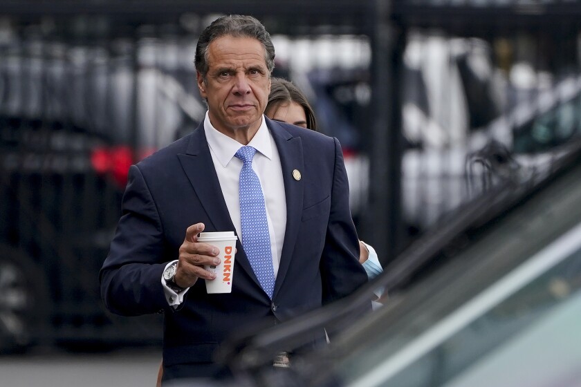 FILE - New York Gov. Andrew Cuomo prepares to board a helicopter after announcing his resignation, Aug. 10, 2021, in New York. Albany's top prosecutor said Tuesday, Jan. 4, 2022, he is dropping a criminal charge accusing former New York Gov. Andrew Cuomo of fondling an aide. (AP Photo/Seth Wenig, File)