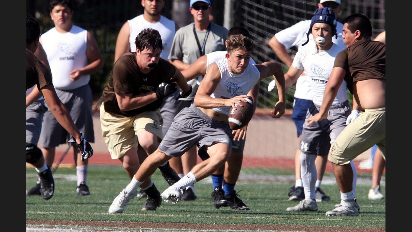 Crescenta Valley's Cole Doyle scrambles after dropping back for a pass and having nobody to pass to in a Spring football scrimmage against St. Francis at St. Francis High School on Wednesday, May 24, 2017.