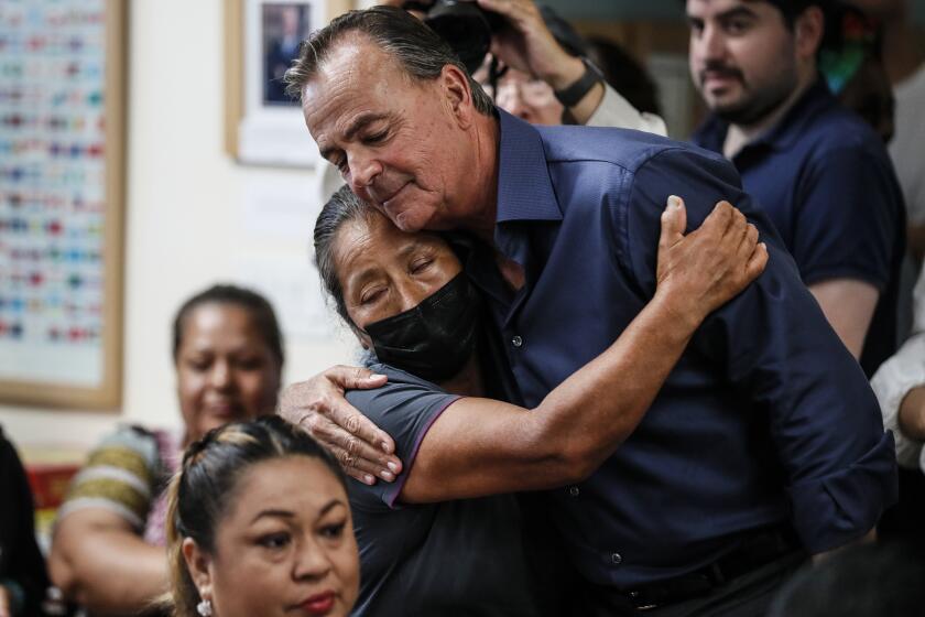 Los Angeles, CA, Sunday, August 28, 2022 - LA Mayoral candidate Rick Caruso embraces resident Francisca Arenas as he conducts a town hall in South LA. (Robert Gauthier/Los Angeles Times)