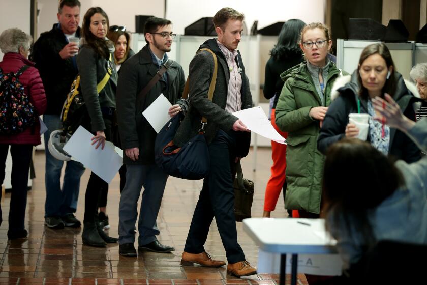 BOSTON - MARCH 3: People wait in line to cast their ballots in the presidential primary election on Super Tuesday, March 3, 2020 at Boston City Hall in Boston on March 3, 2020. (Photo by Jonathan Wiggs/The Boston Globe via Getty Images)