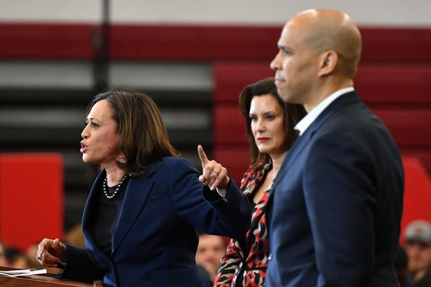 California Senator Kamala Harris (L) speaks as New Jersey Senator Cory Booker (R) and Michigan Governor Gretchen Whitmer (C) listen during a Democratic presidential candidate Joe Biden campaign rally at Renaissance High School in Detroit, Michigan on March 9, 2020. (Photo by MANDEL NGAN / AFP) (Photo by MANDEL NGAN/AFP via Getty Images)