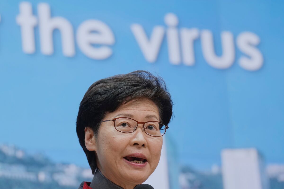 FILE - Hong Kong Chief Executive Carrie Lam speaks during a news conference in Hong Kong, Wednesday, Jan. 5, 2022. One of two people who attended a large gathering with senior Hong Kong officials and was believed to be infected with COVID-19 turned out to be a false positive, meaning about 80 of more than 180 attendees may no longer face a lengthy quarantine. (AP Photo/Vincent Yu, File)