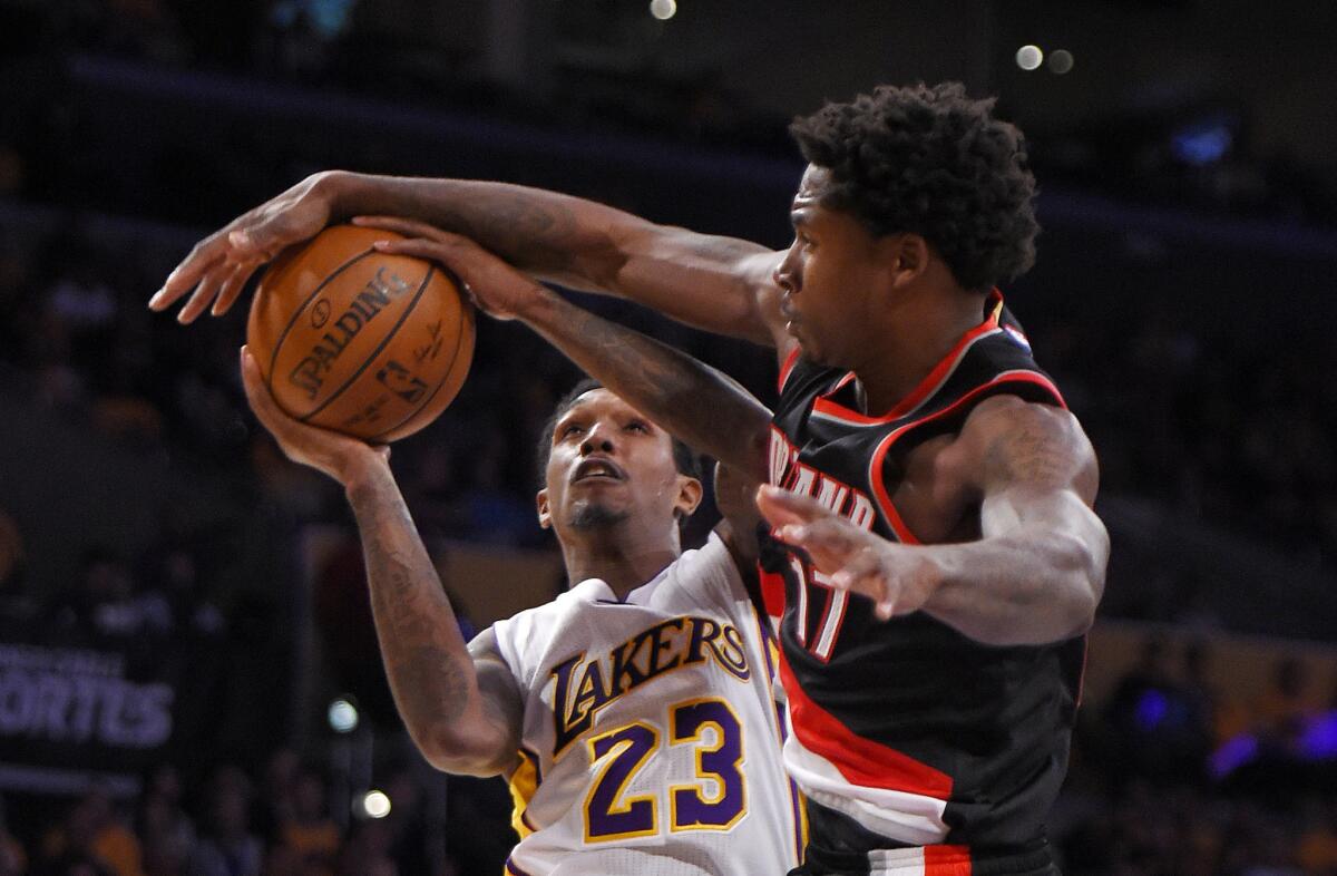 Lakers guard Louis Williams (23) has his shot blocked by Trail Blazers forward Ed Davis, a former Laker, during the second half.