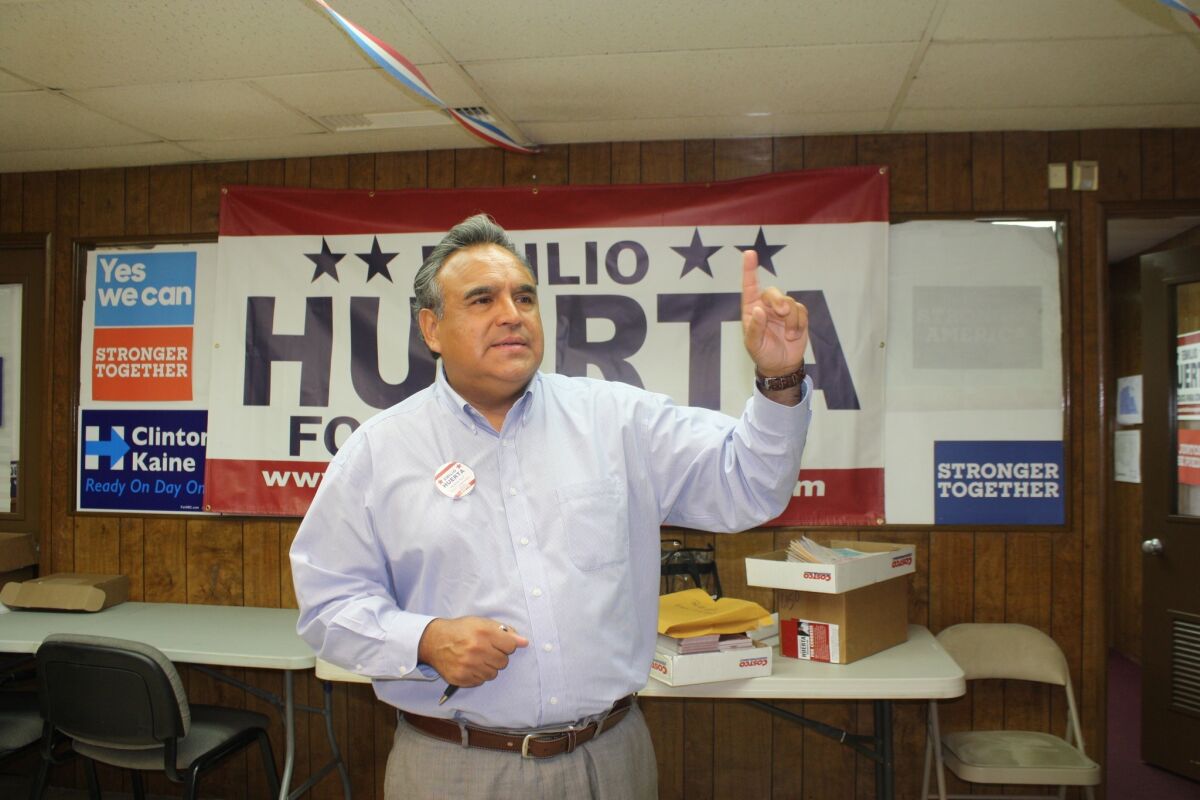 Democratic attorney Emilio Huerta gestures to staff during a tour of his Bakersfield campaign office.