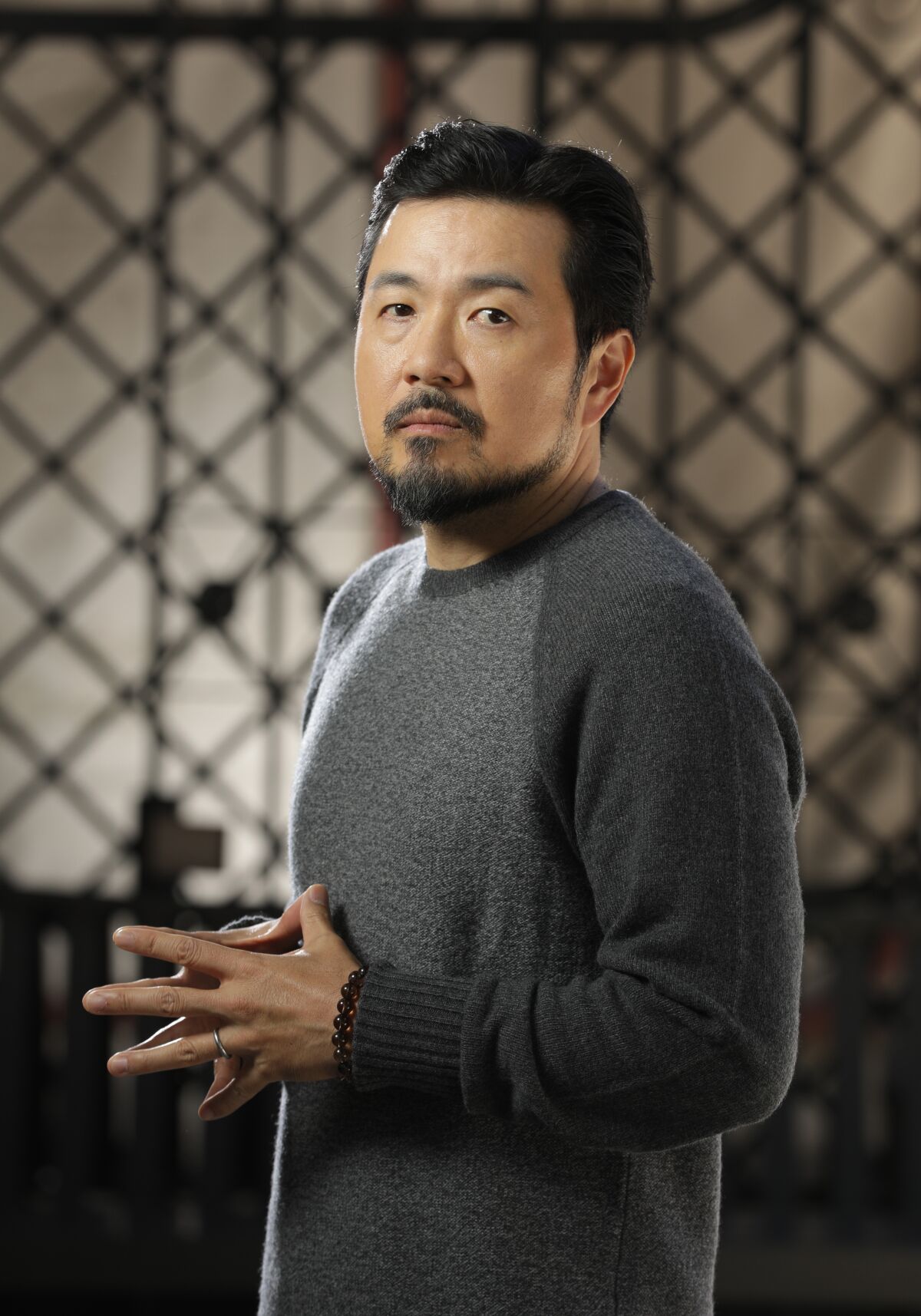 A man in a gray sweater.