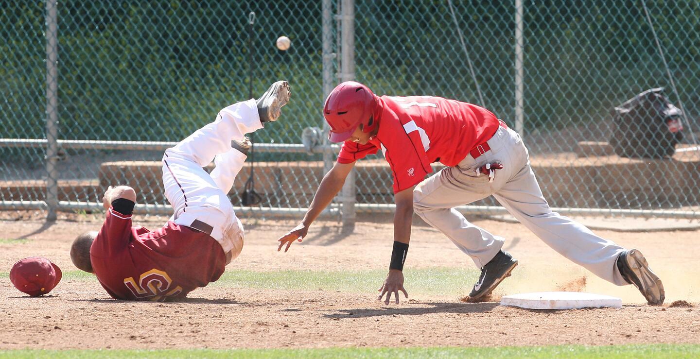 GCC's Jack Sheeley takes a tumble as Pierce's Angel Cruz makes safe back to first and then makes it to second during a game on Wednesday, April 15, 2014.