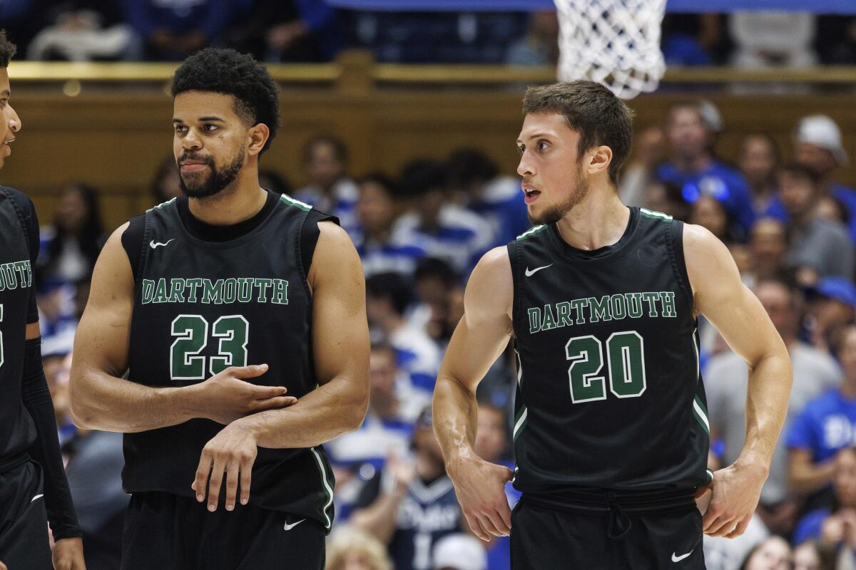Dartmouth's Robert McRae III (23) and Romeo Myrthil (20) walk onto the court during a game against Duke.