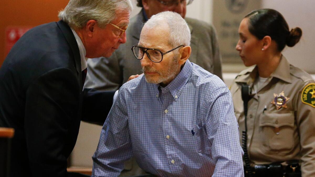 Robert Durst, center, pictured at an earlier hearing speaking with his attorney, Dick DeGuerin, appeared in court Sept. 20 for a hearing in his murder case.
