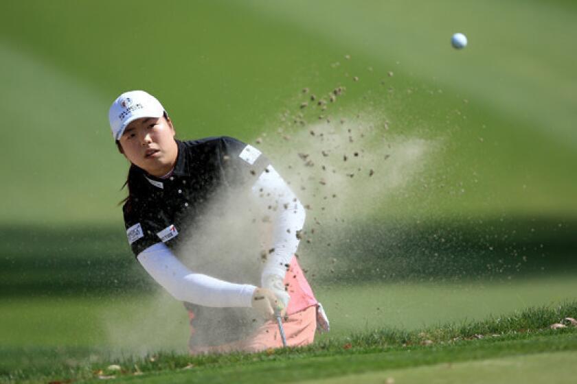 Shanshan Feng plays out of a bunker on the 11th hole during the first round of the Kraft Nabisco Championship at Mission Hills Country Club in Rancho Mirage on Thursday.