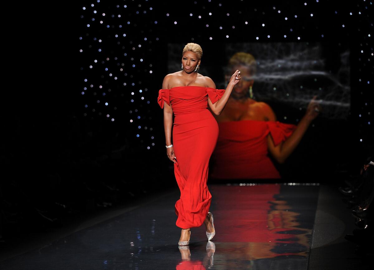 Actress and TV personality NeNe Leakes models an outfit from the American Heart Assn.'s 2014 Red Dress Collection. She will join the cast of "Zumanity" for a short run in June and July.