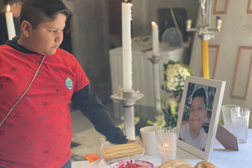 Bryan Osvaldo Hernandez, 10 (left) looks at altar placed for his brother and victim Brandon Giovanni Hernandez Tapia , 12 (in photo table). Brandon Giovannis family set up an altar in his honor at his family home in the Tlahuac neighborhood of Mexico City, to commemorate Brandon Giovannis passing on May 3. He was the youngest victim of the Metro accident on May 3 , Mexico City where 26 were killed.