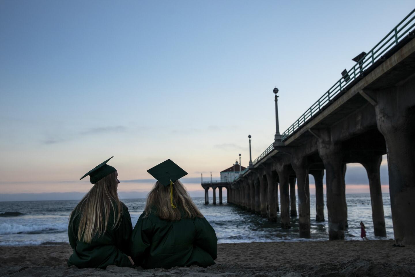 Cameron Johnson,18, left, and Simona Krasnegor,17, watched the sun set while sitting next to the Manhattan Beach Pier.