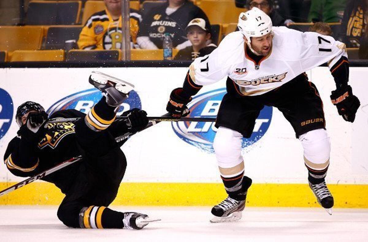 Ducks winger Dustin Penner knocks down Bruins defenseman Torey Krug during a game last week at TD Garden in Boston.
