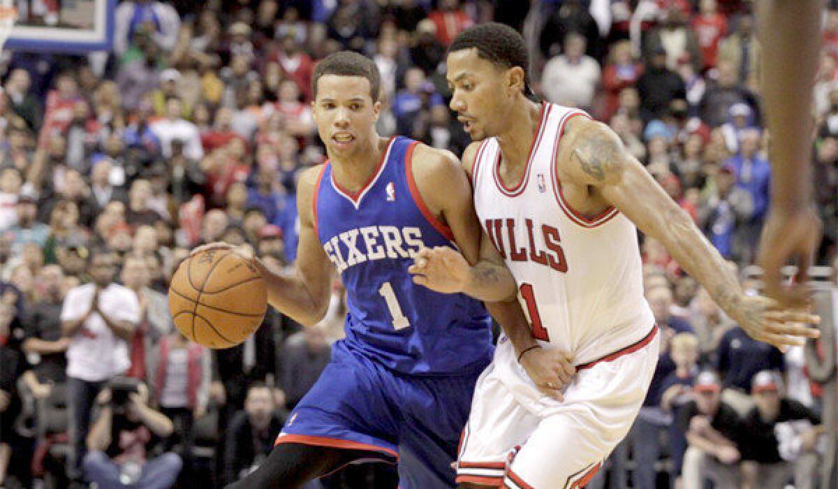 Philadelphia guard Michael Carter-Williams tries to get around the defense of Chicago's Derrick Rose during the 76ers' 107-104 win over the Bulls. Carter-Williams had 26 points and 10 assists in the victory.