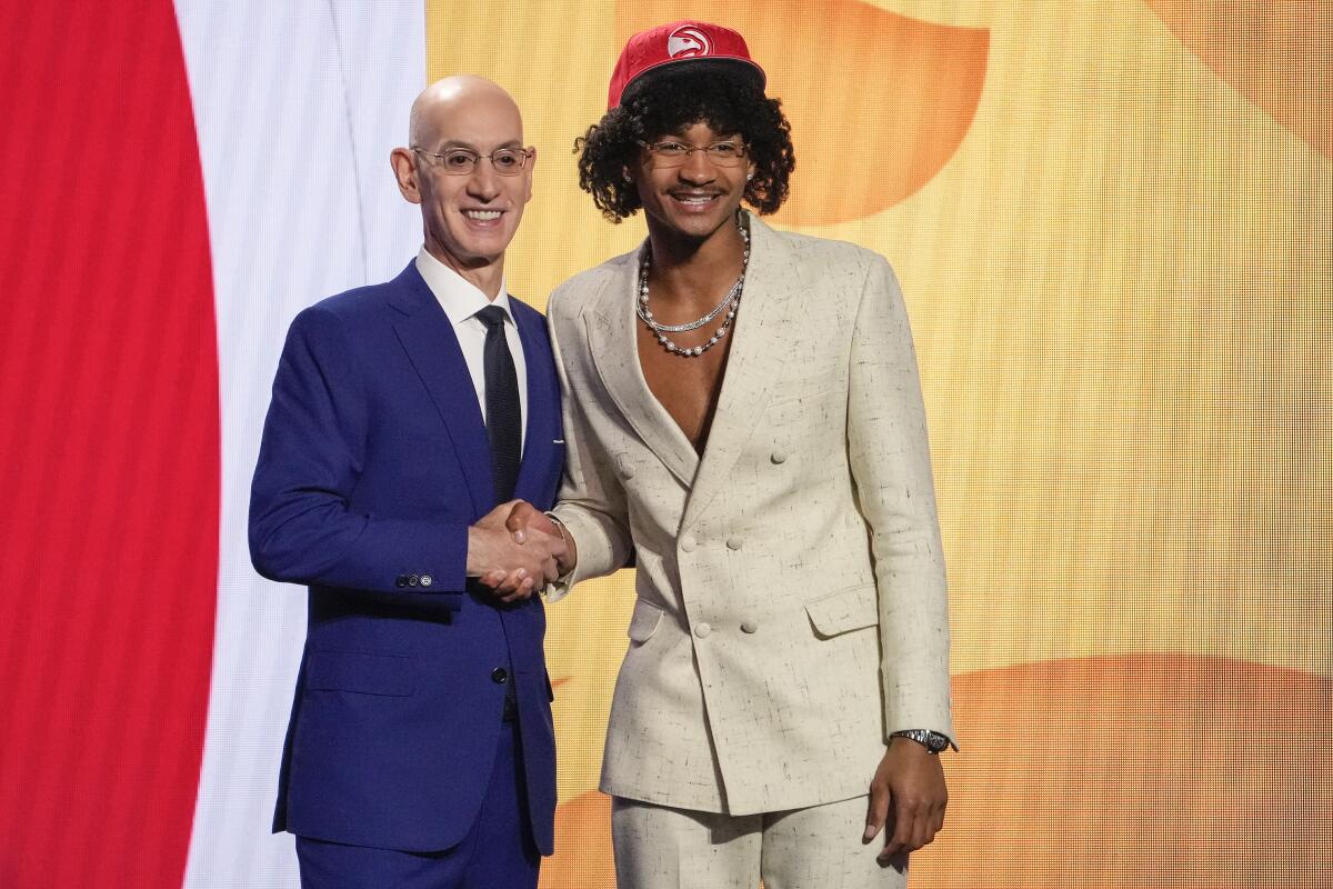 Kobe Bufkin poses for a photo with NBA Commissioner Adam Silver after being selected 15th overall by the Atlanta Hawks.