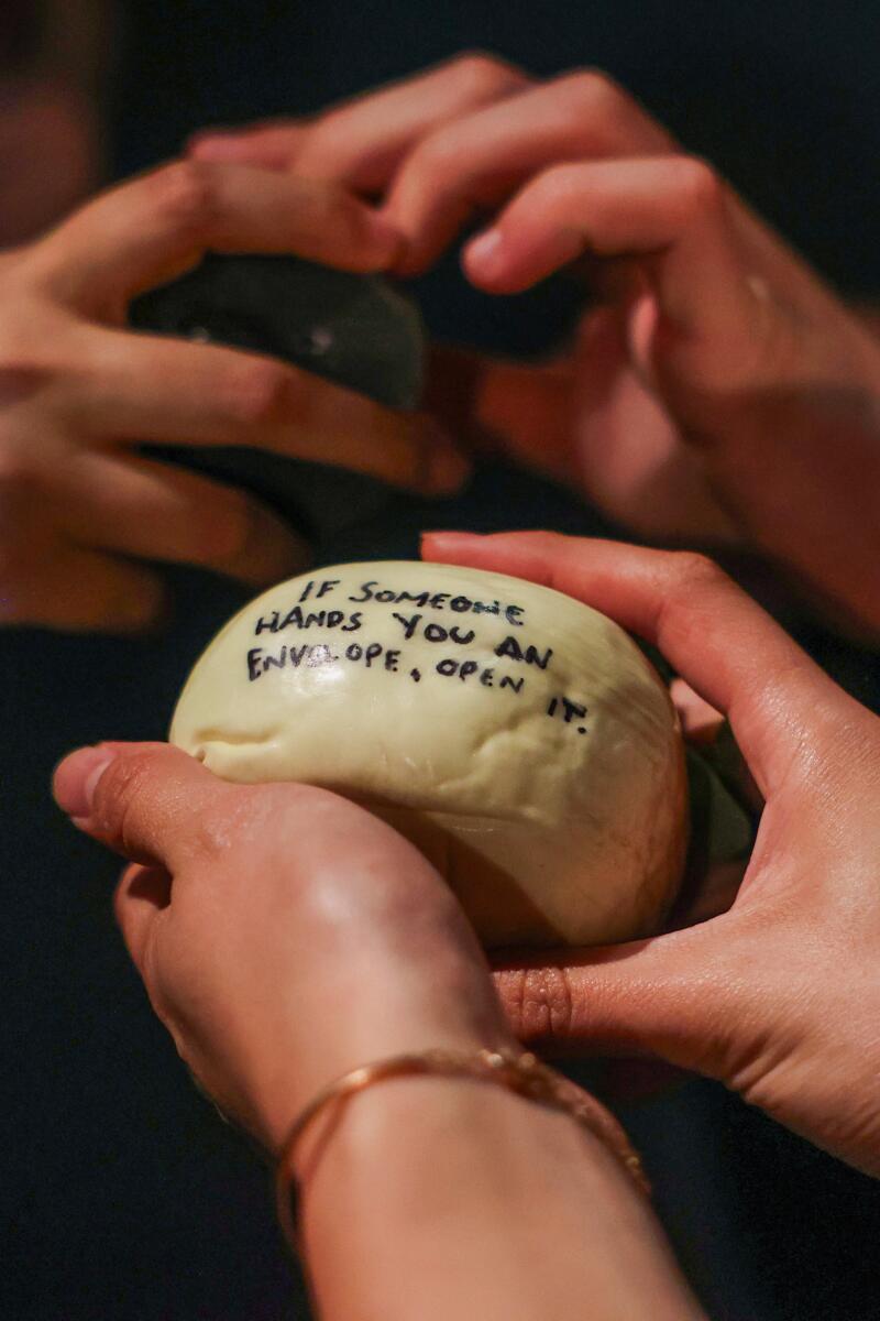 Melanie Pentecost holds a rock that gives the next context clue to move the play forward.